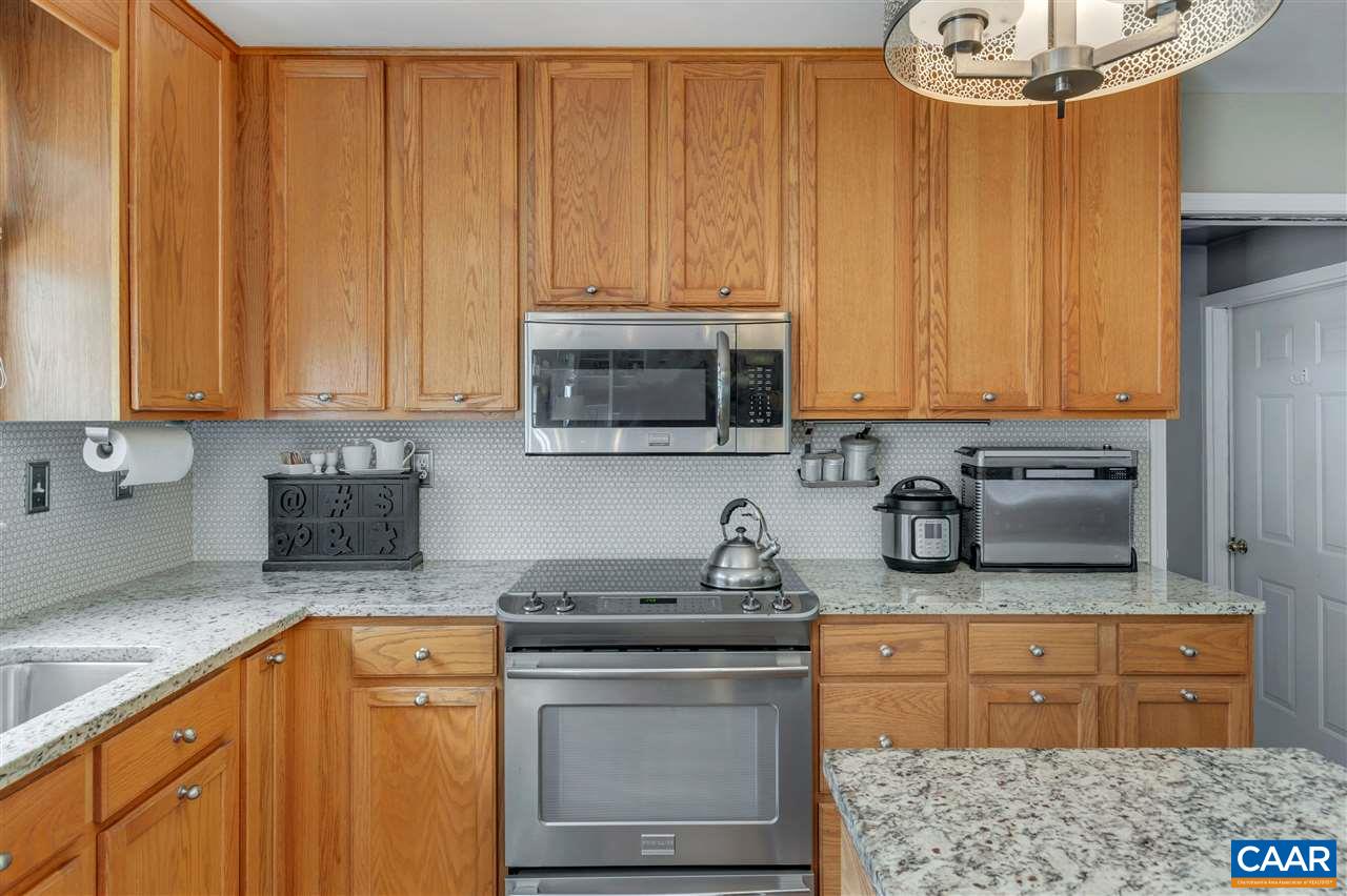 1209 Raintree Drive Charlottesville, VA 22901 - Photo 21 of 46 a kitchen with stainless steel appliances granite countertop a sink stove and microwave