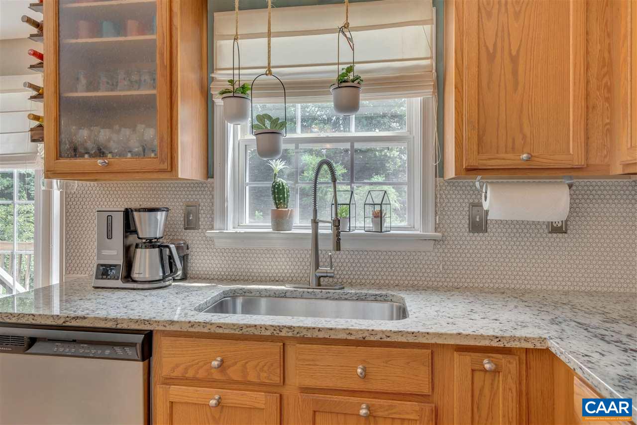 1209 Raintree Drive Charlottesville, VA 22901 - Photo 23 of 46 a kitchen with granite countertop a sink and a window