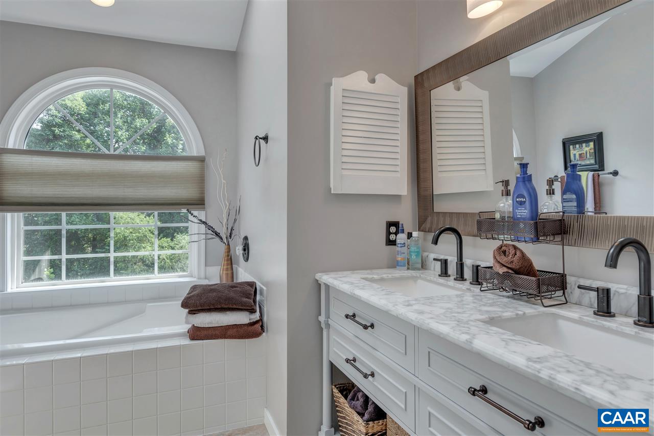 1209 Raintree Drive Charlottesville, VA 22901 - Photo 29 of 46 a bathroom with a granite countertop sink a large window and mirror