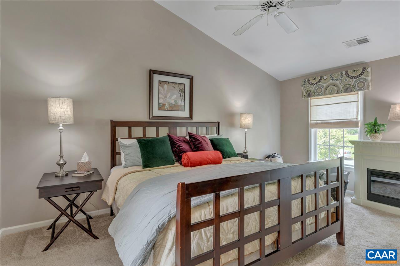 1209 Raintree Drive Charlottesville, VA 22901 - Photo 32 of 46 a bedroom with a bed a chandelier and dresser