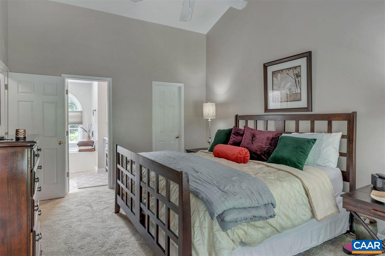 1209 Raintree Drive Charlottesville, VA 22901 - Photo 36 of 46 a bedroom with a bed and a chandelier