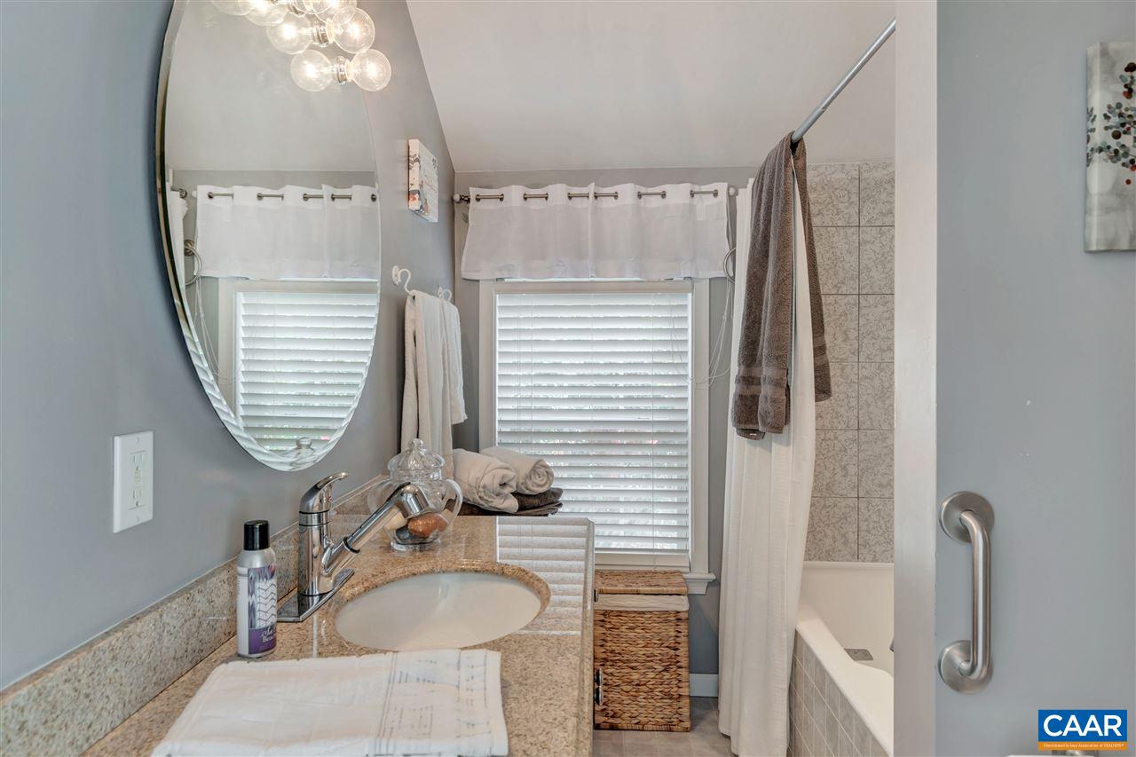 1209 Raintree Drive Charlottesville, VA 22901 - Photo 39 of 46 a bathroom with a tub sink and mirror
