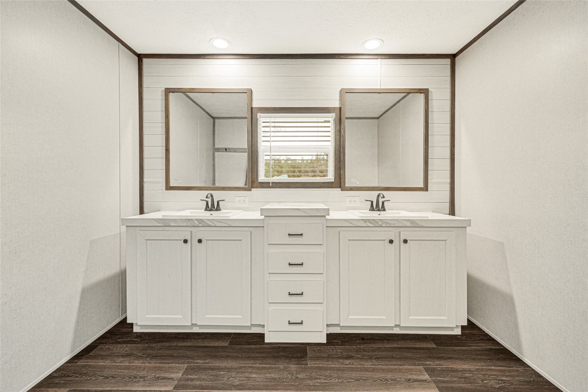 718 Main Street Anahuac, TX 77514 - Photo 11 of 26 a bathroom with a double vanity sink and mirror