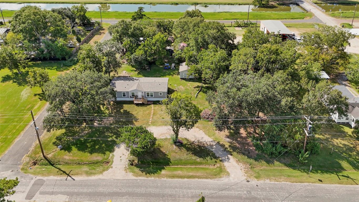 718 Main Street Anahuac, TX 77514 - Photo 13 of 26 an aerial view of a house with a yard basket ball court and outdoor seating