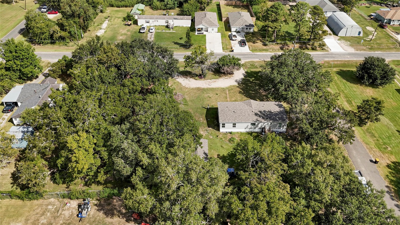 718 Main Street Anahuac, TX 77514 - Photo 14 of 26 an aerial view of residential house with outdoor space and trees all around