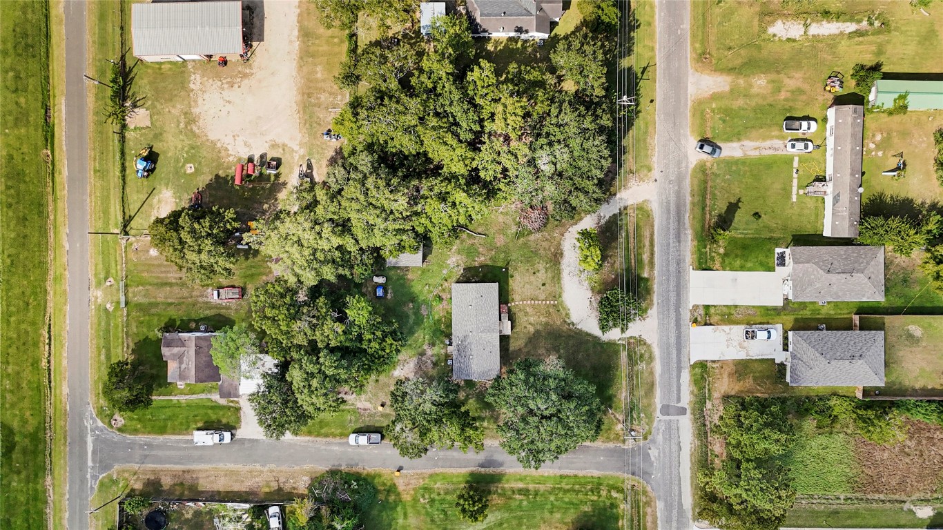 718 Main Street Anahuac, TX 77514 - Photo 15 of 26 an aerial view of a residential houses with trees