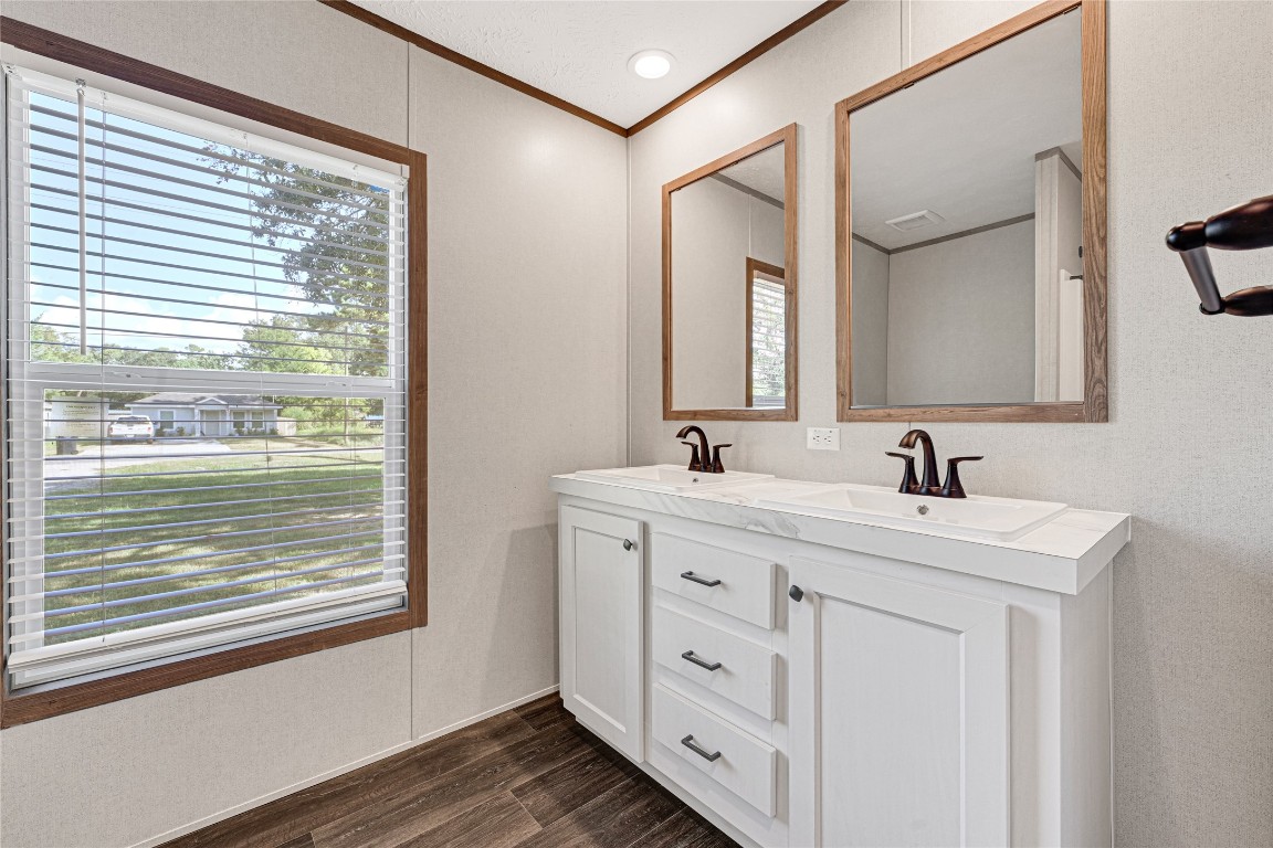 718 Main Street Anahuac, TX 77514 - Photo 18 of 26 a bathroom with a sink a mirror and a window