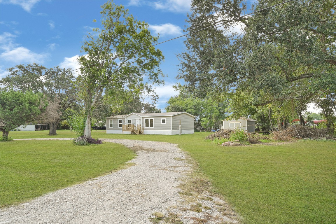718 Main Street Anahuac, TX 77514 - Photo 23 of 26 a front view of a house with garden