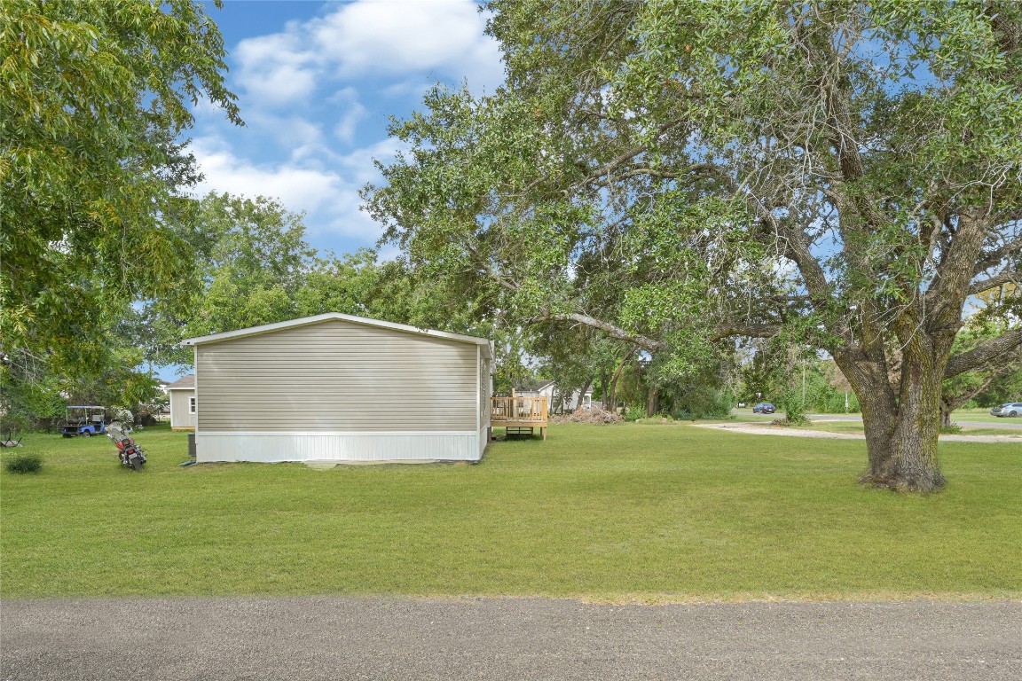 718 Main Street Anahuac, TX 77514 - Photo 25 of 26 a house with trees in the background