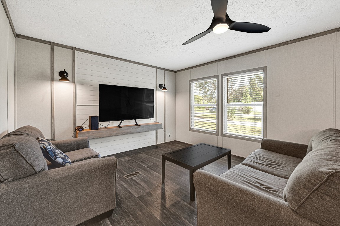 718 Main Street Anahuac, TX 77514 - Photo 6 of 26 a living room with furniture and a flat screen tv