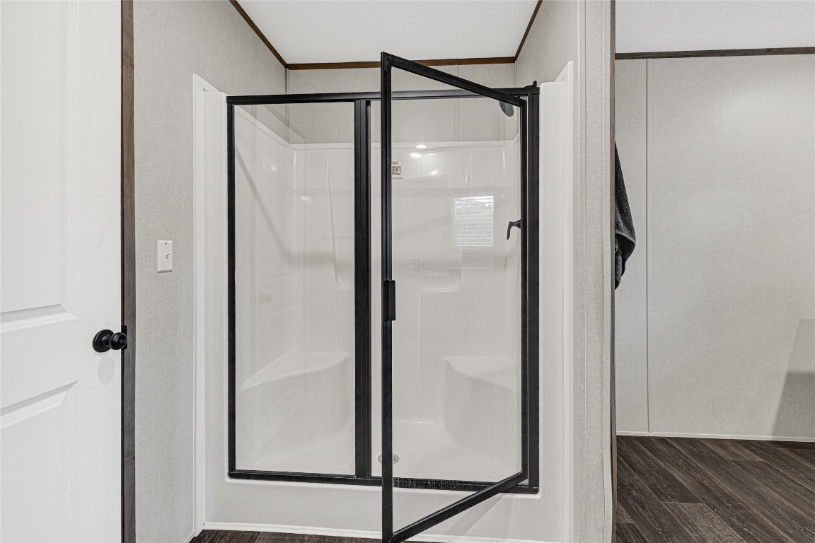 718 Main Street Anahuac, TX 77514 - Photo 10 of 26 a bathroom with a glass shower door