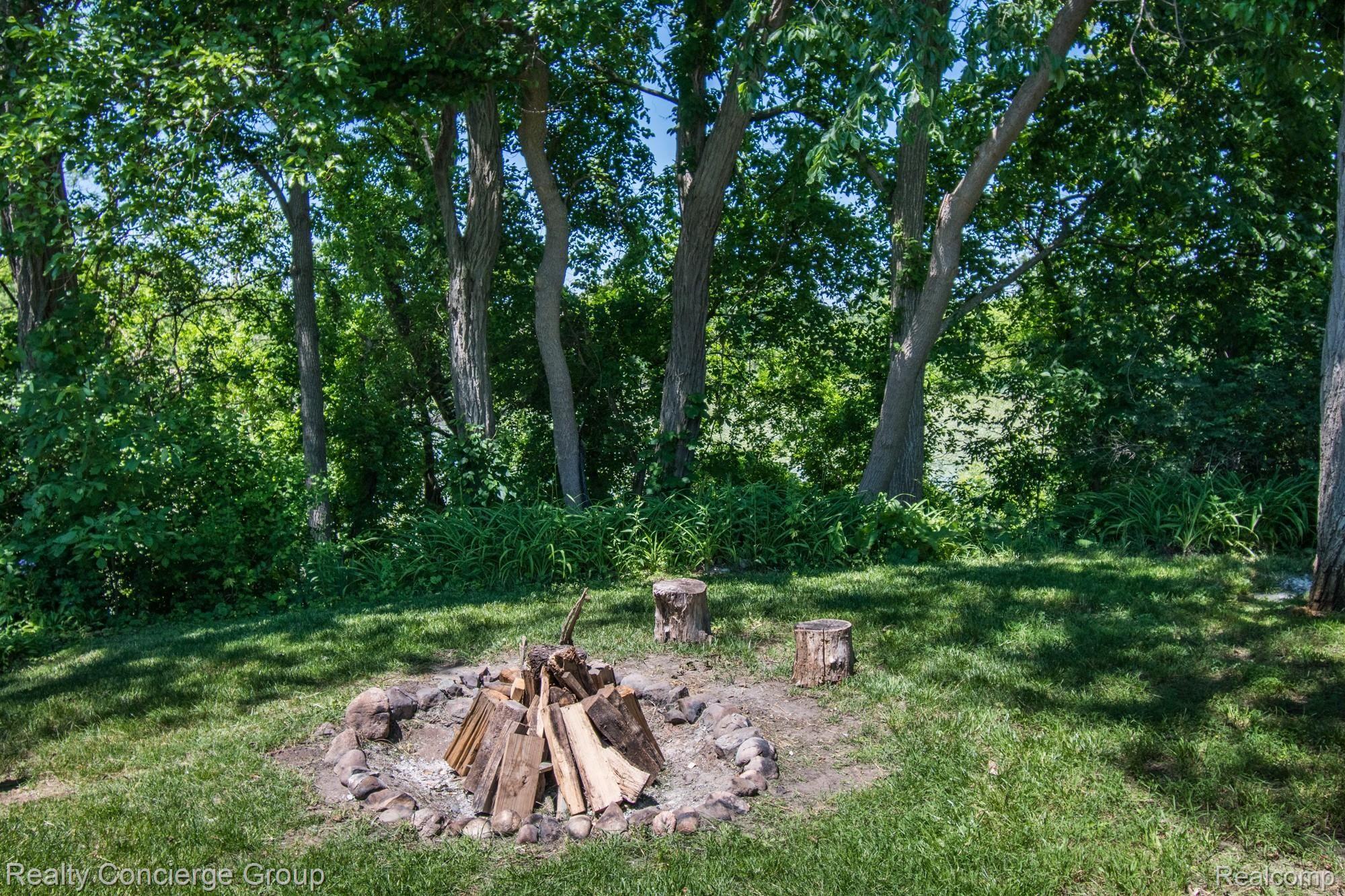 7503 Challis Road Brighton, MI 48116 - Photo 23 of 27 Fire pit and views of pond