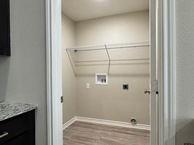 a kitchen with a refrigerator and a stove top oven