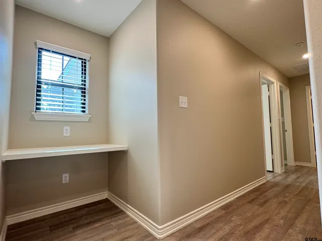 an empty room with a window and a ceiling fan