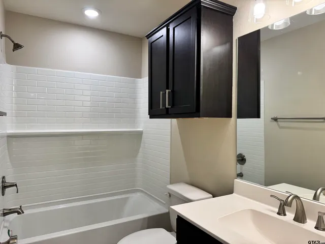 an empty room with wooden floor and closet