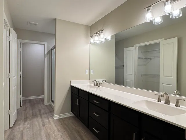 a bathroom with a glass shower door