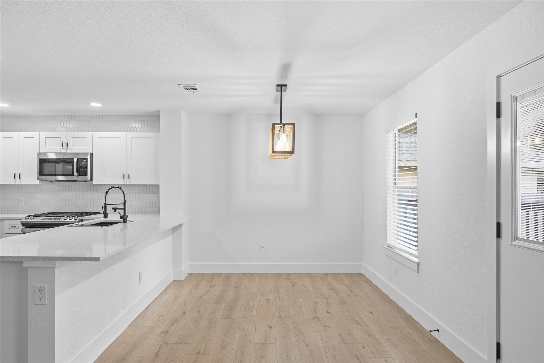 6708 Panda Royle Drive Del Valle, TX 78617 - Photo 11 of 40 a kitchen with stainless steel appliances granite countertop a sink a stove and a refrigerator