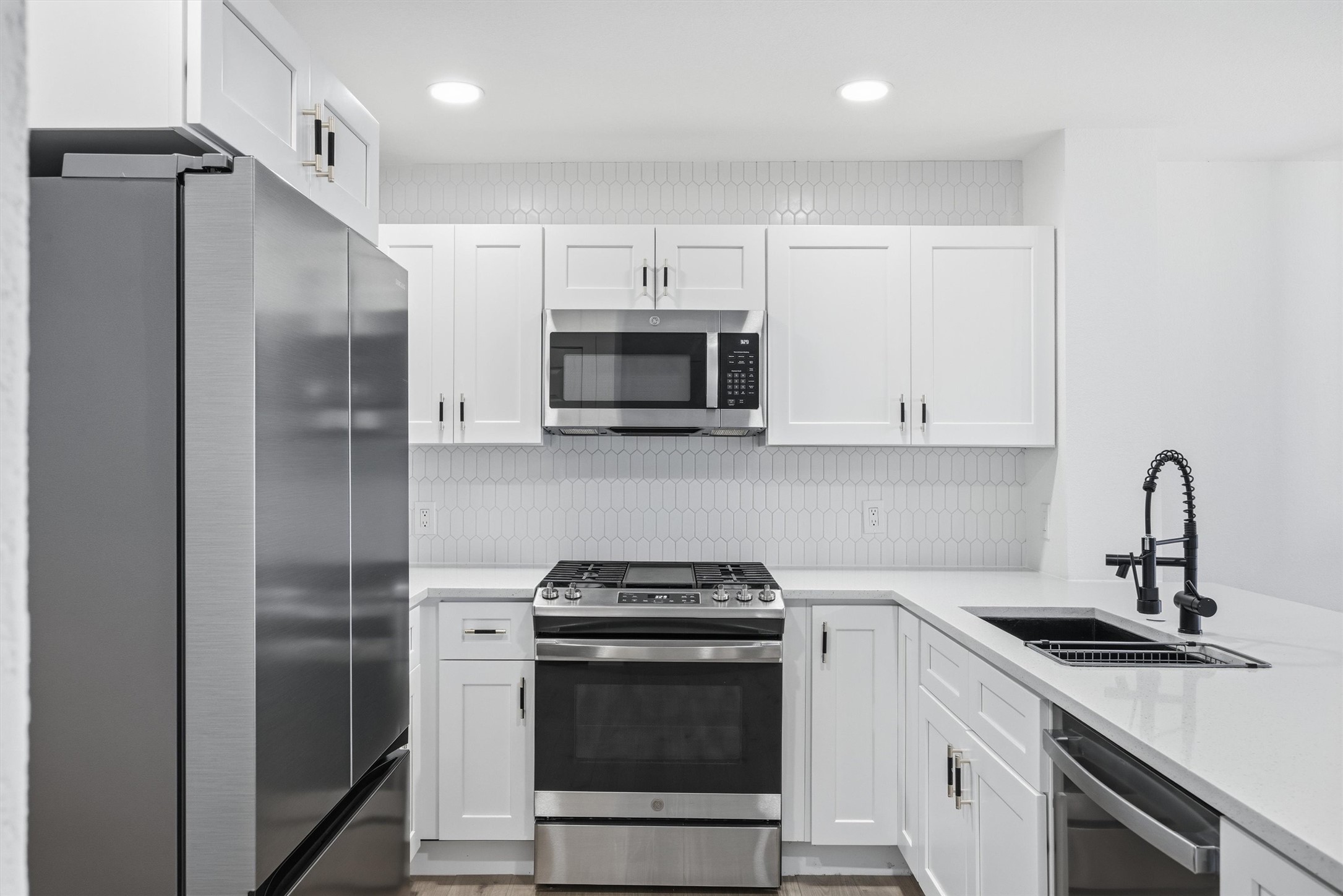 6708 Panda Royle Drive Del Valle, TX 78617 - Photo 12 of 40 a kitchen with a sink stainless steel appliances and cabinets
