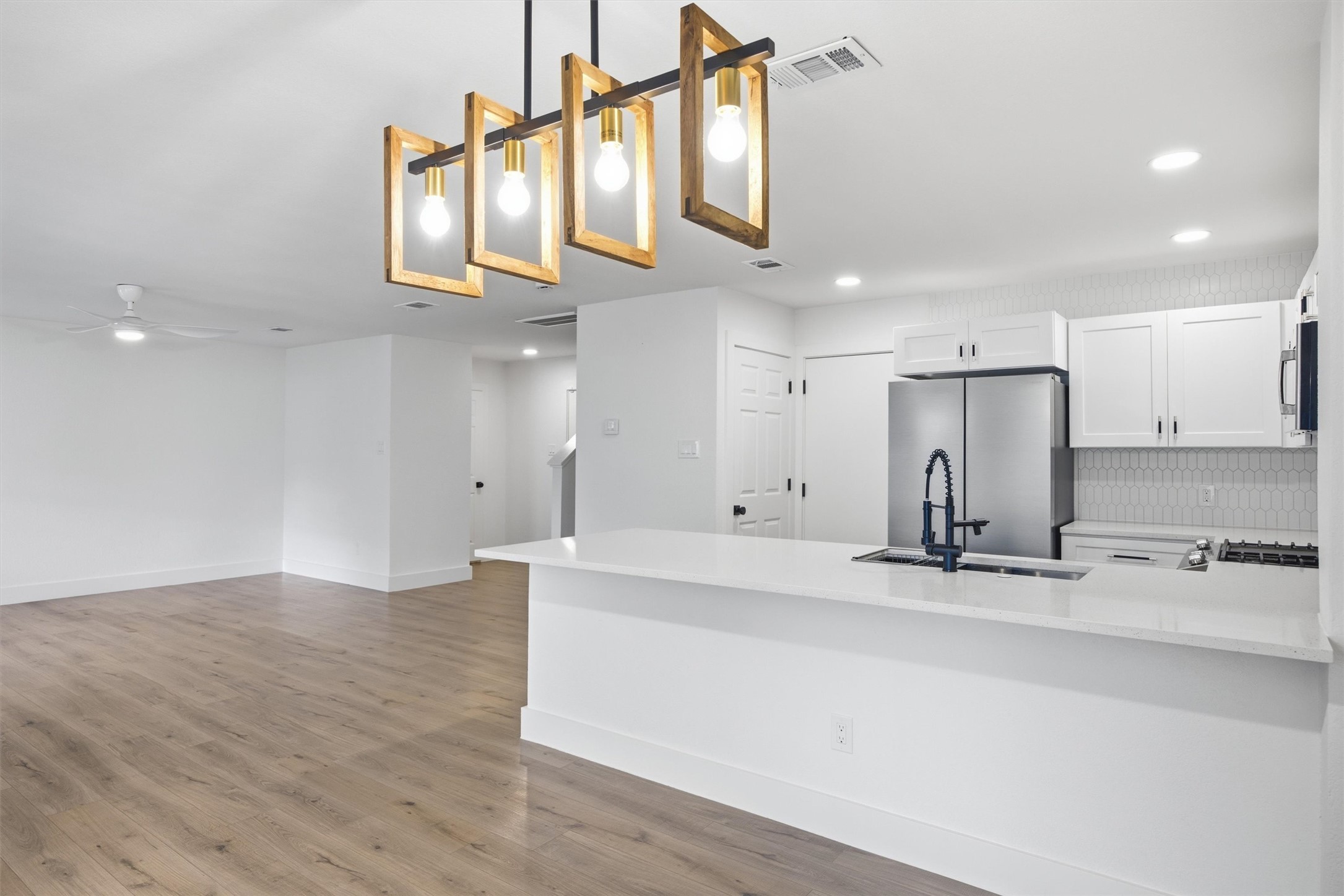 6708 Panda Royle Drive Del Valle, TX 78617 - Photo 14 of 40 a kitchen with stainless steel appliances granite countertop a sink and a refrigerator