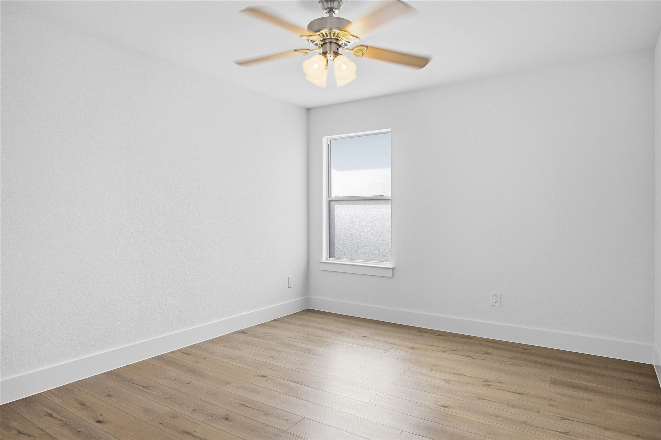 6708 Panda Royle Drive Del Valle, TX 78617 - Photo 19 of 40 an empty room with a window and a chandelier fan