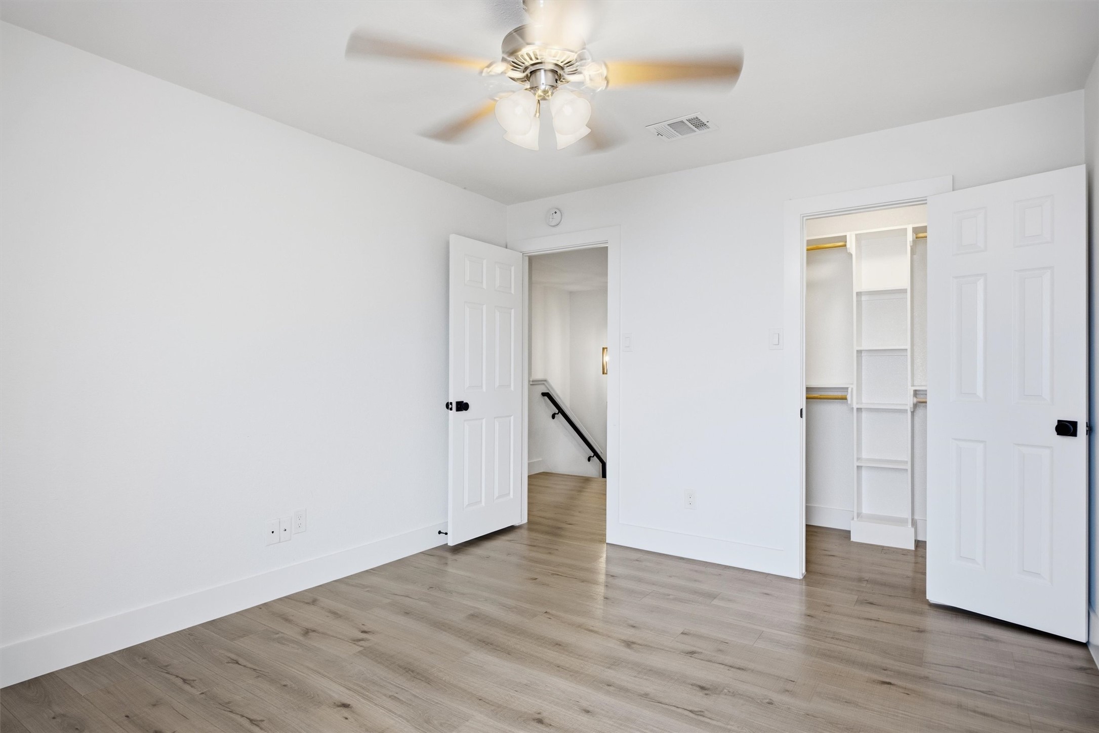 6708 Panda Royle Drive Del Valle, TX 78617 - Photo 22 of 40 an empty room with wooden floor and ceiling fan