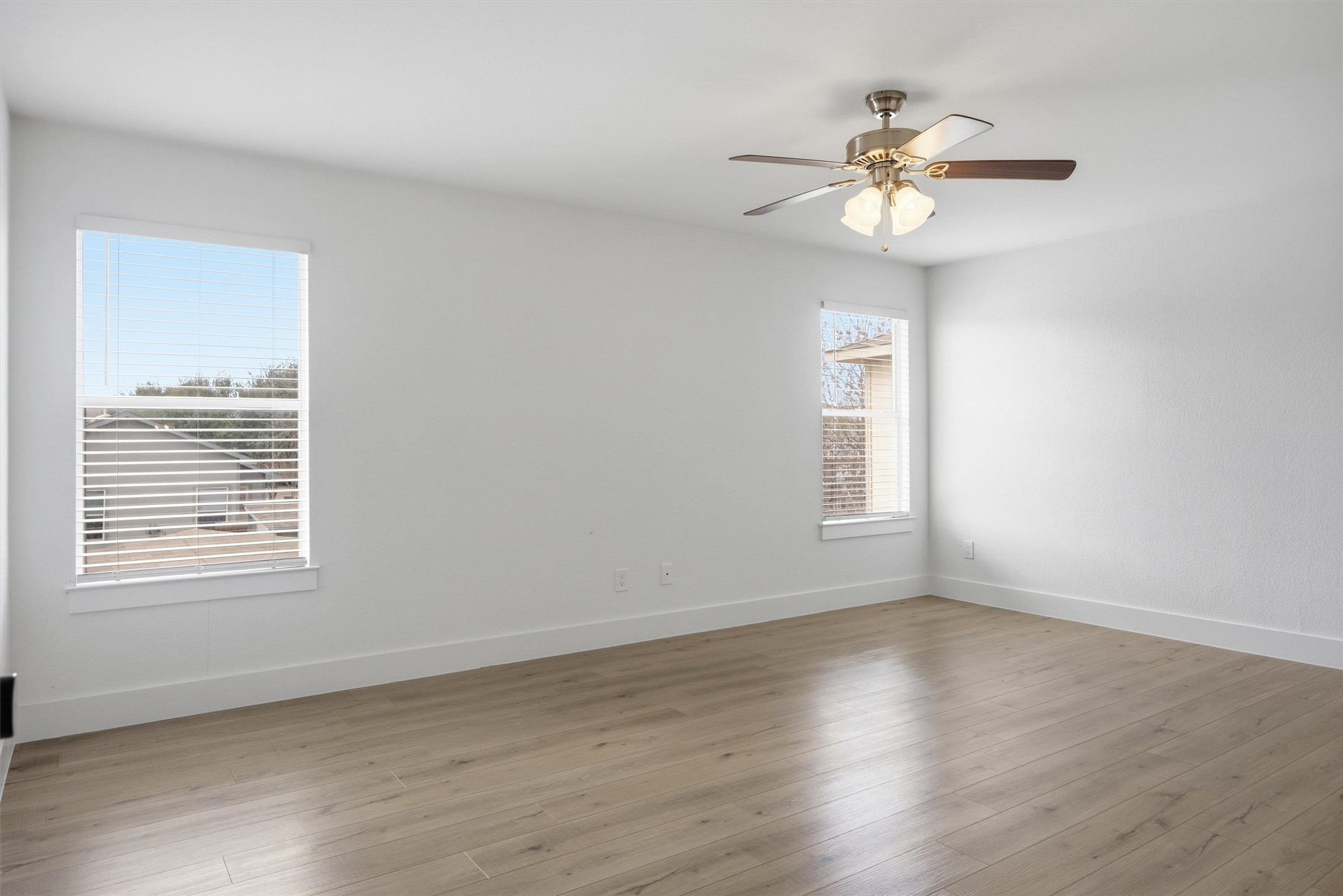 6708 Panda Royle Drive Del Valle, TX 78617 - Photo 23 of 40 a view of an empty room with wooden floor and a window