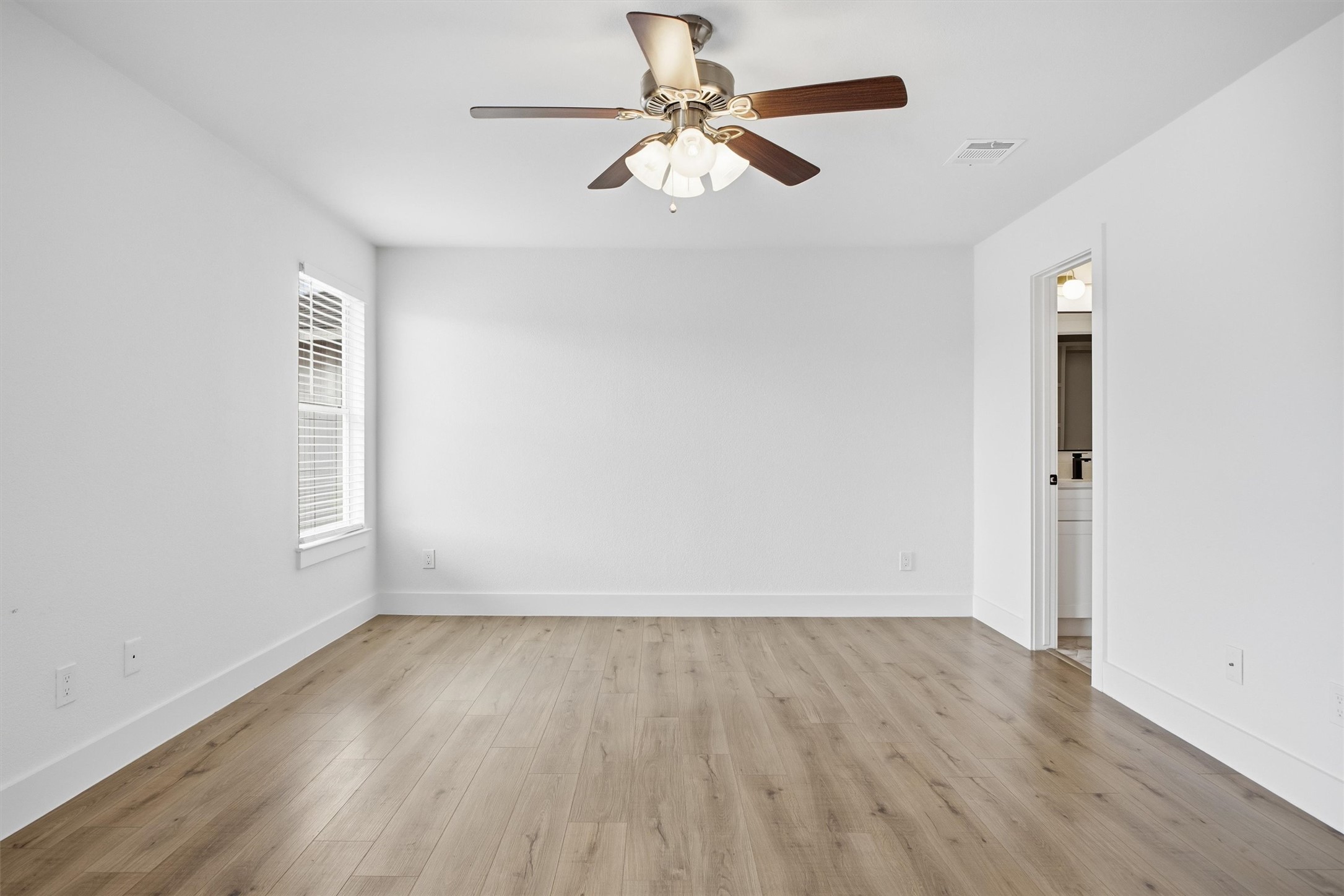 6708 Panda Royle Drive Del Valle, TX 78617 - Photo 24 of 40 wooden floor in an empty room with a window