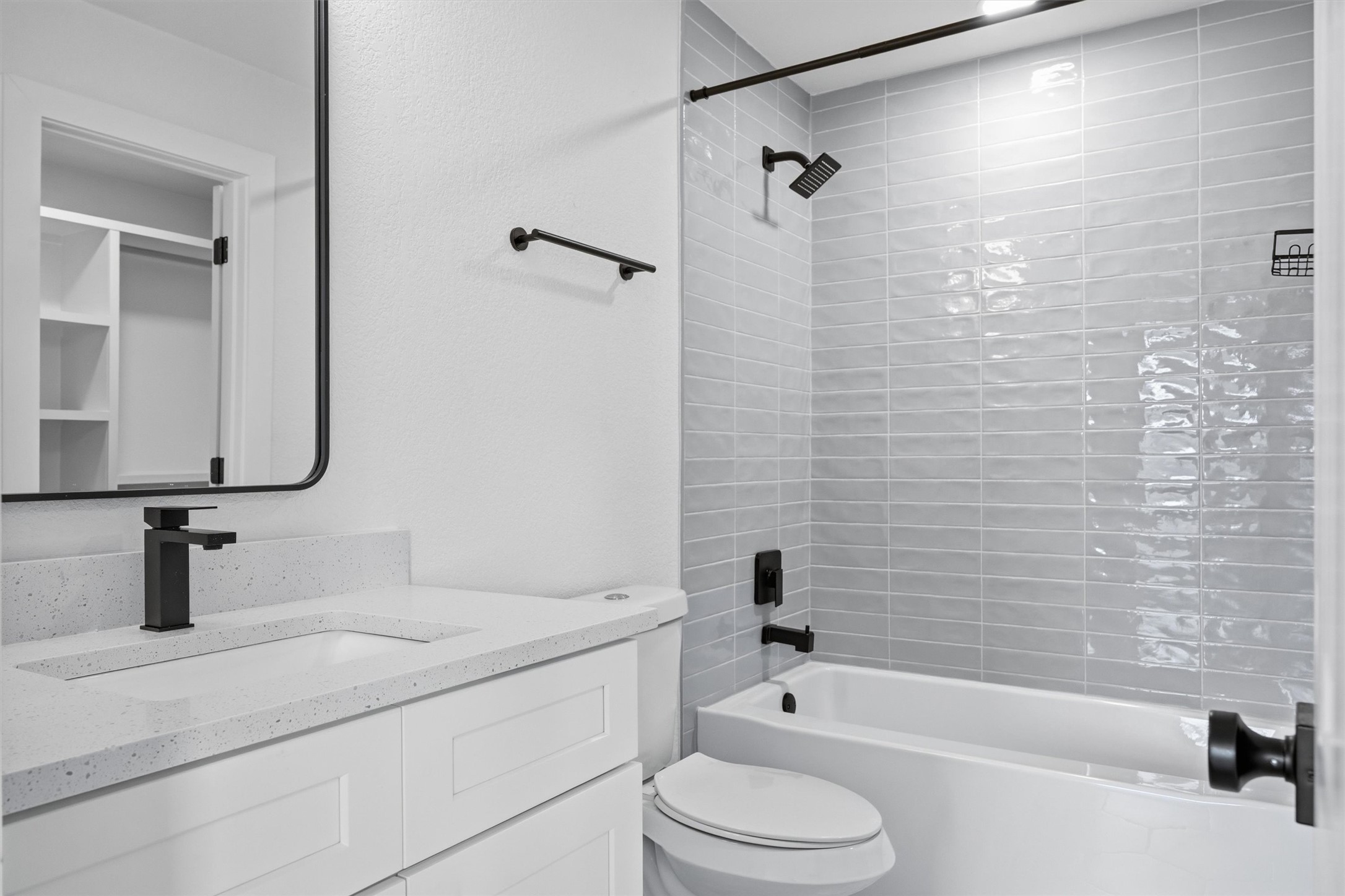 6708 Panda Royle Drive Del Valle, TX 78617 - Photo 26 of 40 a bathroom with a bathtub shower sink vanity and toilet