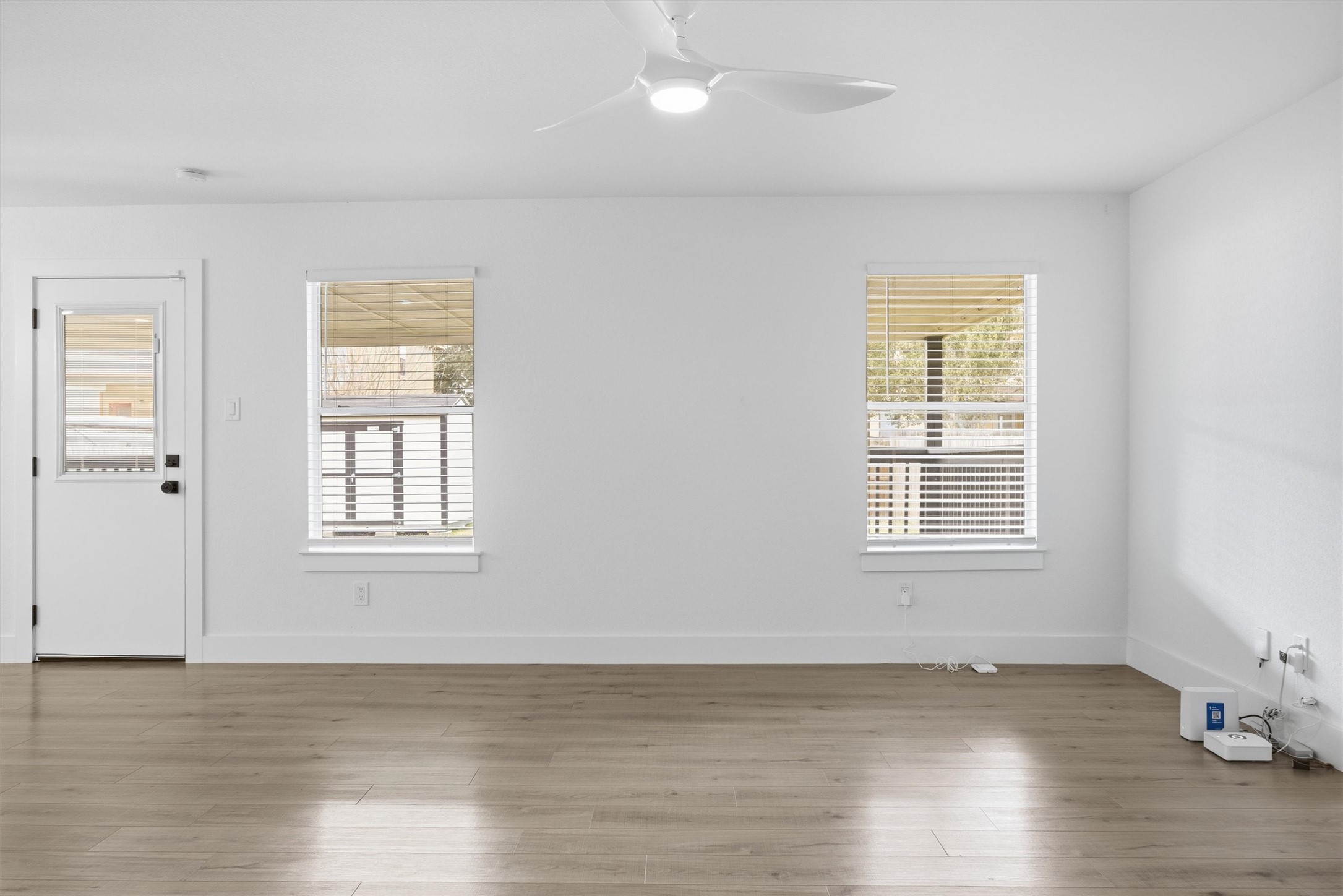 6708 Panda Royle Drive Del Valle, TX 78617 - Photo 5 of 40 a view of an empty room with wooden floor and a window