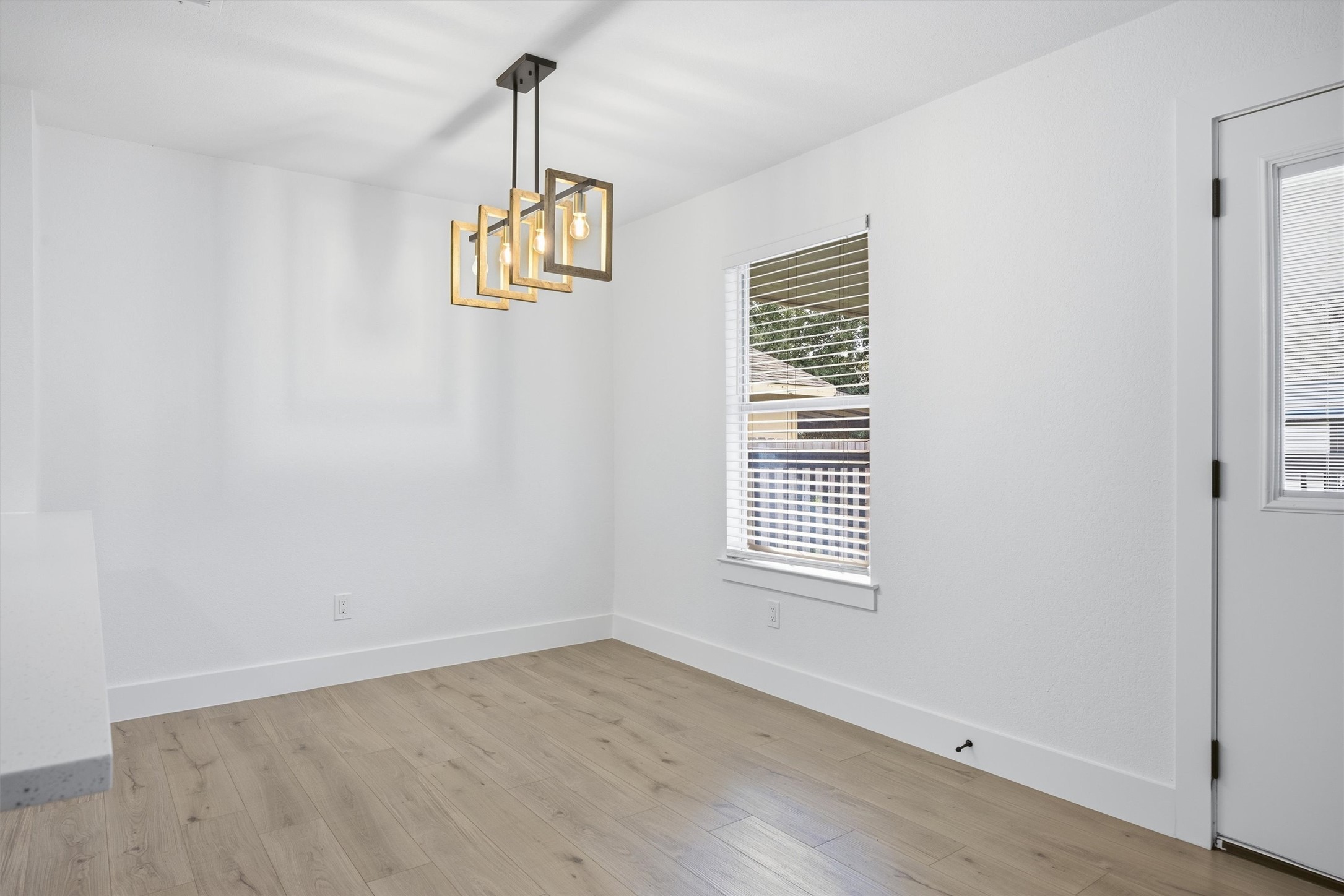 6708 Panda Royle Drive Del Valle, TX 78617 - Photo 7 of 40 wooden floor in an empty room with a window