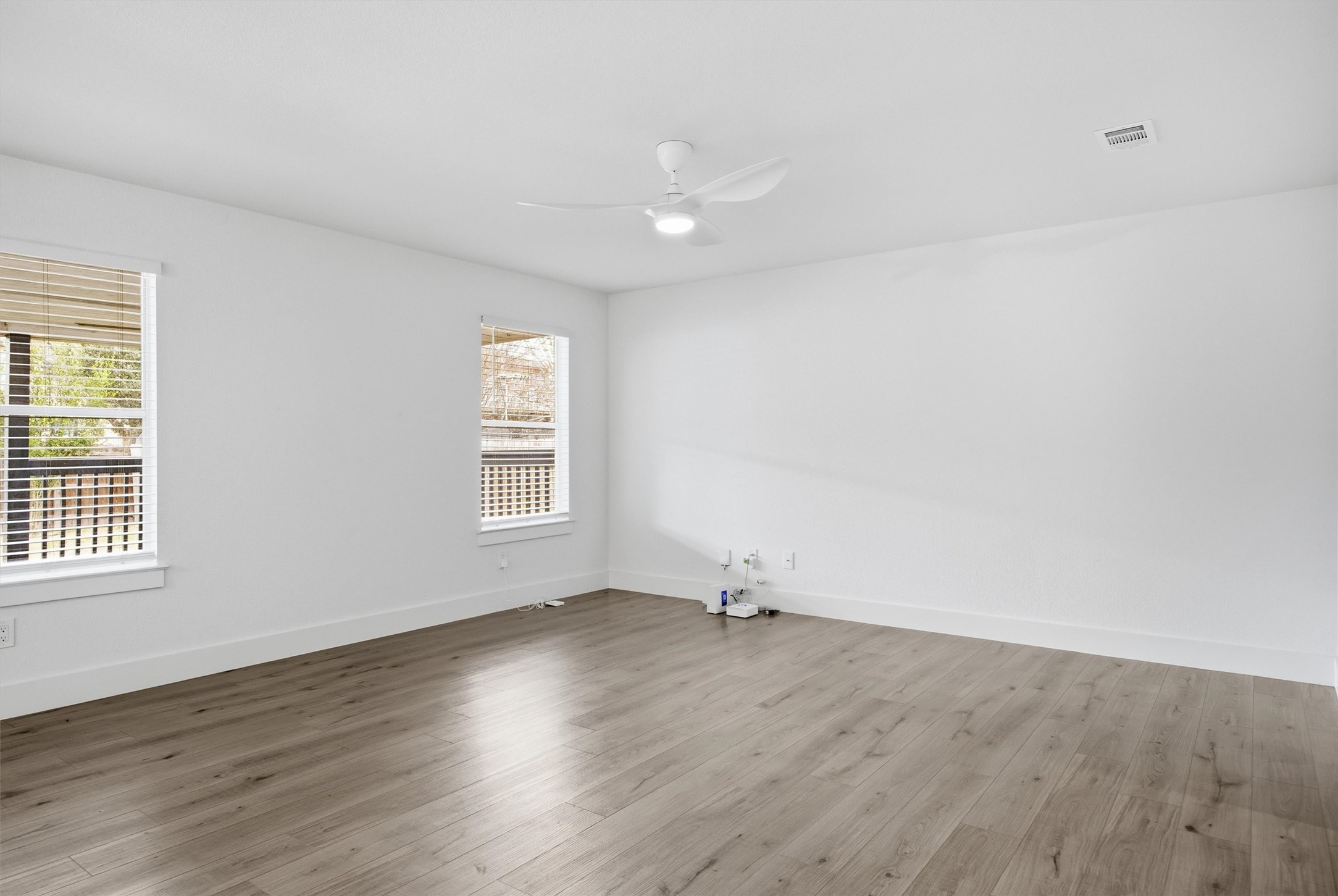 6708 Panda Royle Drive Del Valle, TX 78617 - Photo 8 of 40 an empty room with wooden floor and windows