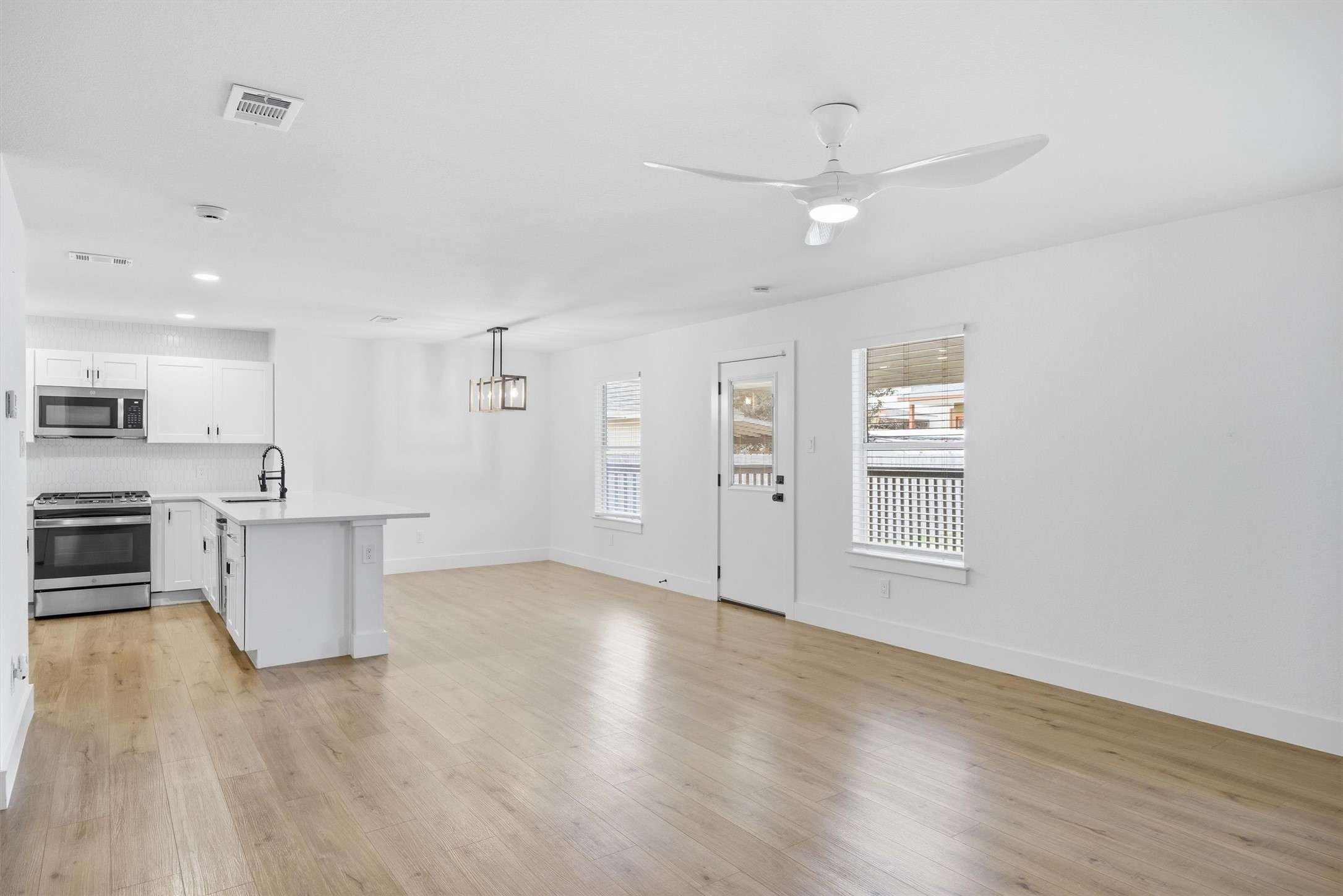6708 Panda Royle Drive Del Valle, TX 78617 - Photo 9 of 40 a view of an empty room with kitchen and window