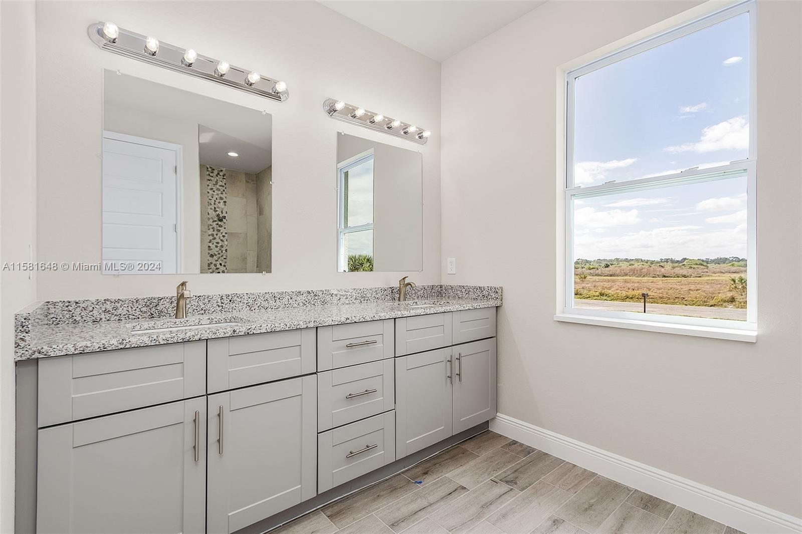 8035 Melody Circle LaBelle, FL 33935 - Photo 14 of 20 a bathroom with double sink and a mirror