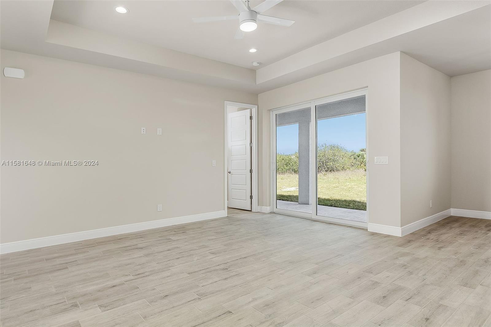 8035 Melody Circle LaBelle, FL 33935 - Photo 10 of 20 an empty room with wooden floor and windows