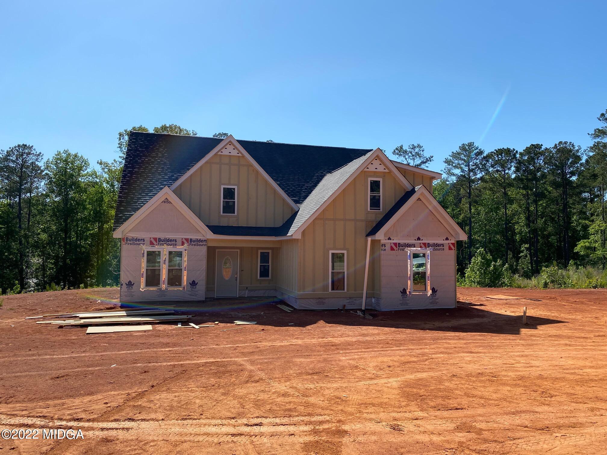 65 Jenkins Road Forsyth, GA 31029 - Photo 1 of 10 a front view of a house with a yard