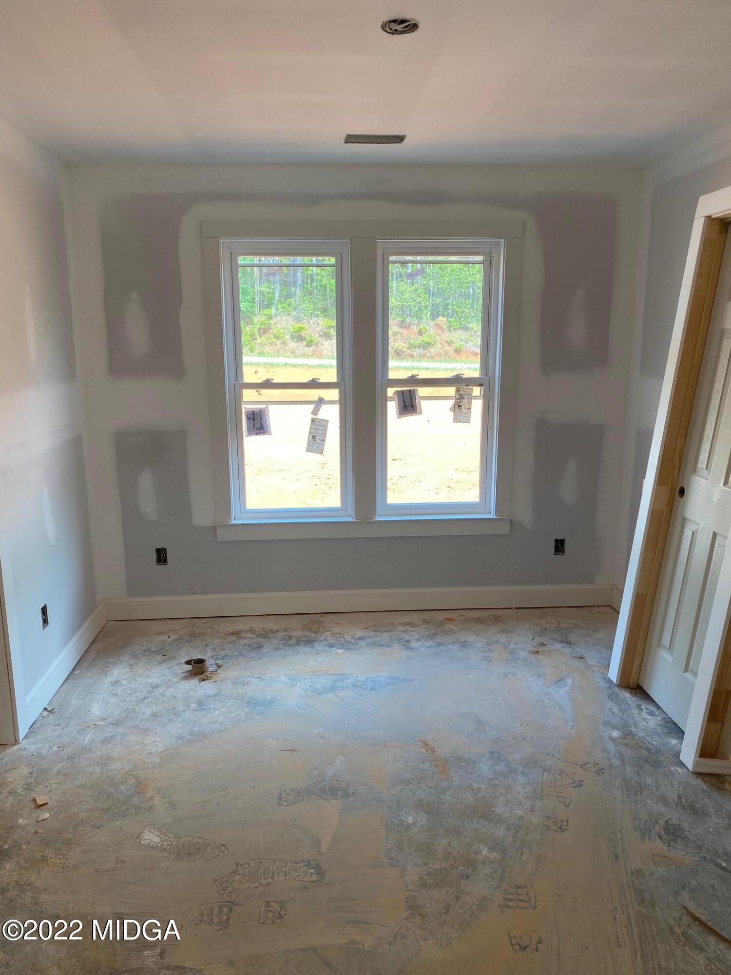 65 Jenkins Road Forsyth, GA 31029 - Photo 6 of 10 an empty room with windows