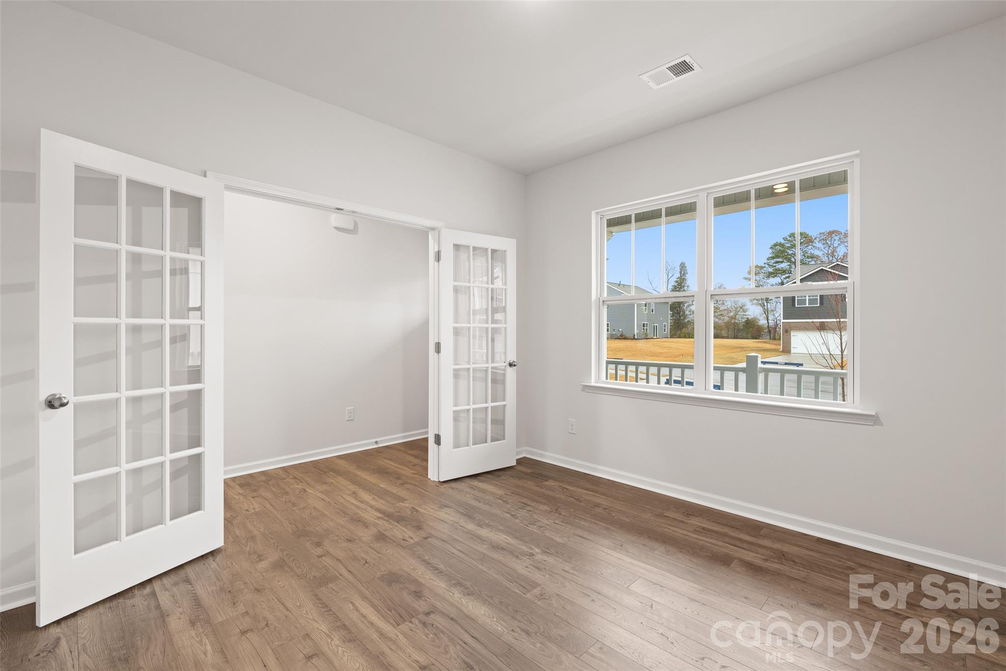 132 Salers Road Fletcher, NC 28732 - Photo 5 of 29 an empty room with wooden floor and windows