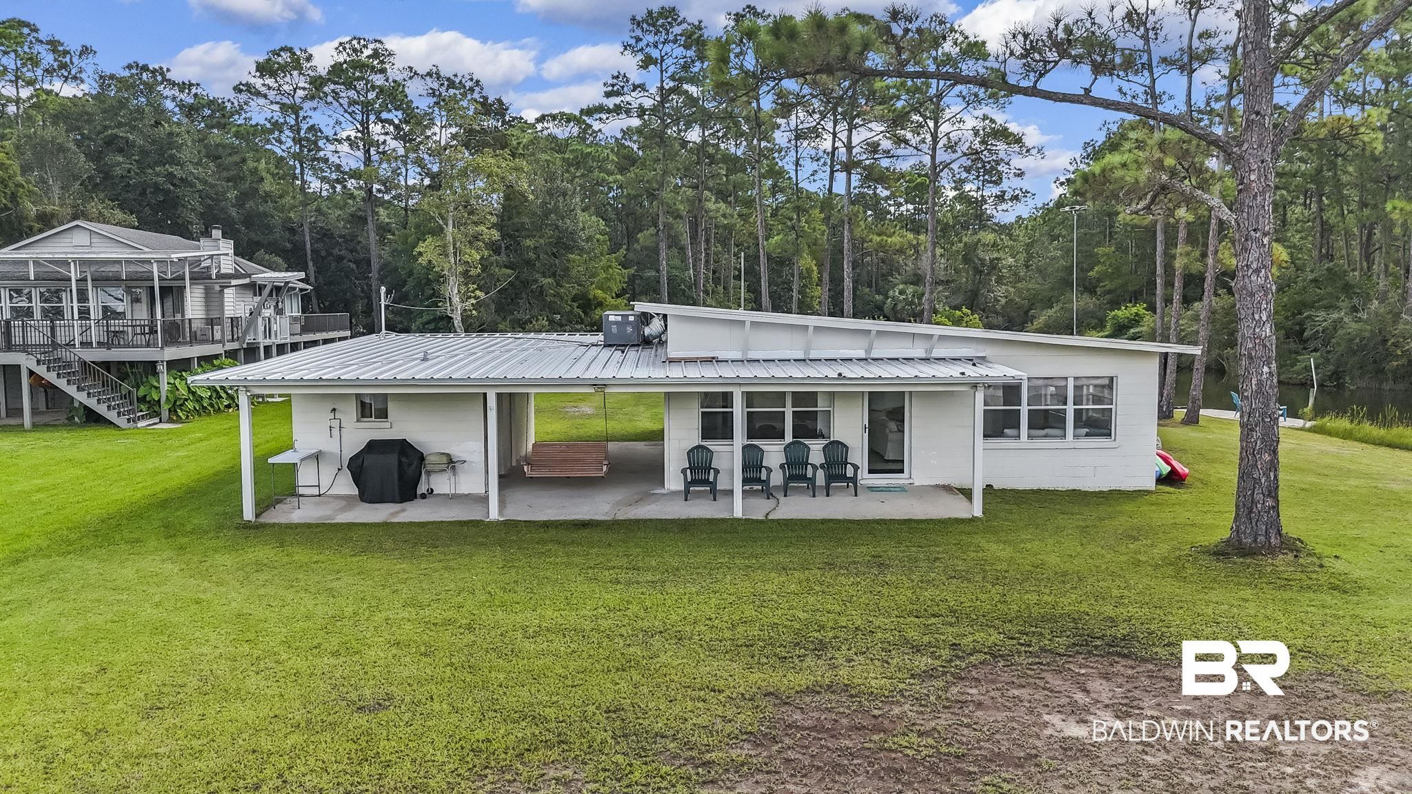 7849 Bayshore Drive Elberta, AL 36530 - Photo 6 of 47 Back of house with cooling unit, a deck, a lawn, and a patio area