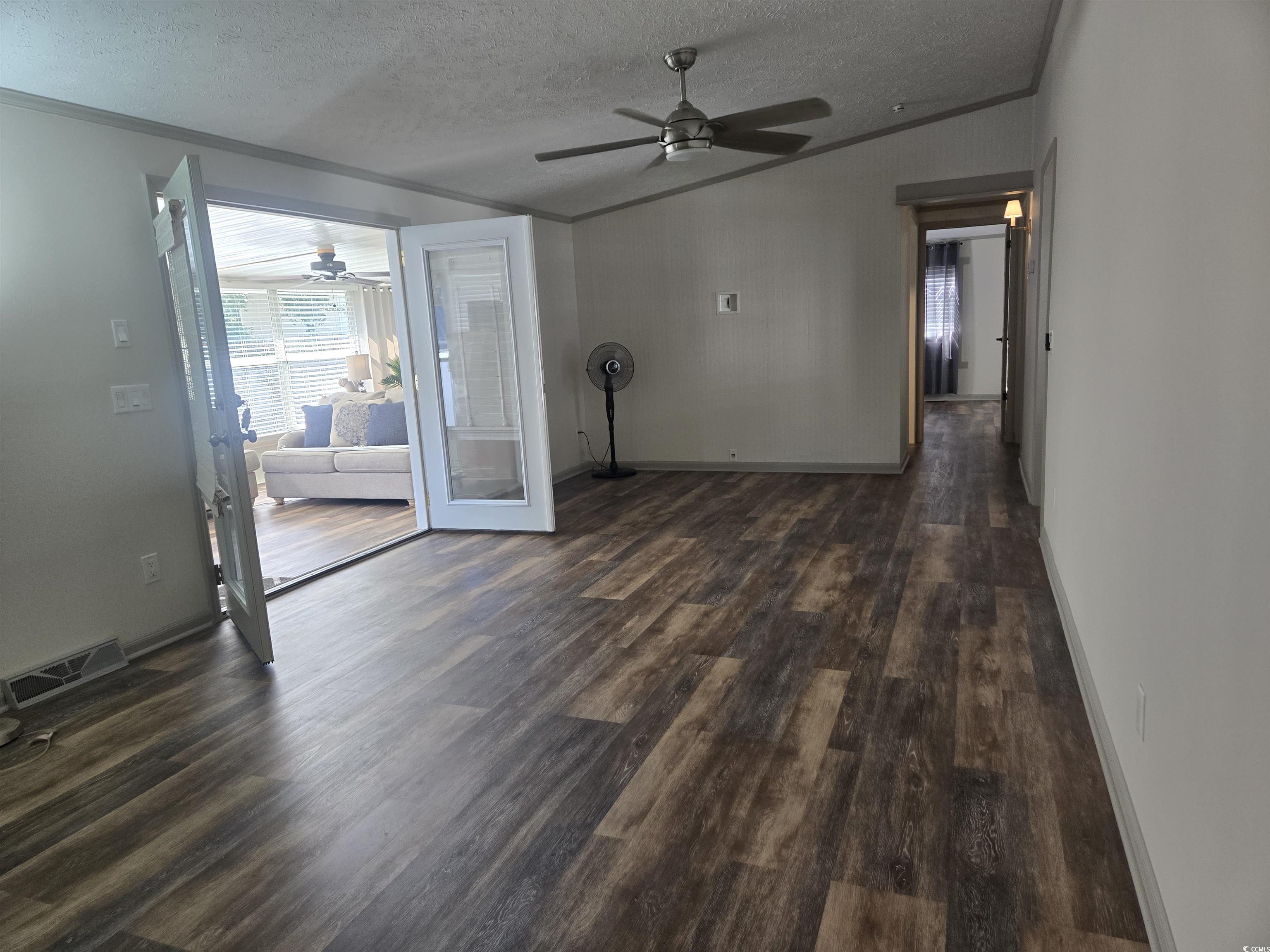 359 Lagoon Circle Murrells Inlet, SC 29576 - Photo 16 of 39 Unfurnished room featuring a textured ceiling, ornamental molding, dark wood finished floors, vaulted ceiling, and ceiling fan