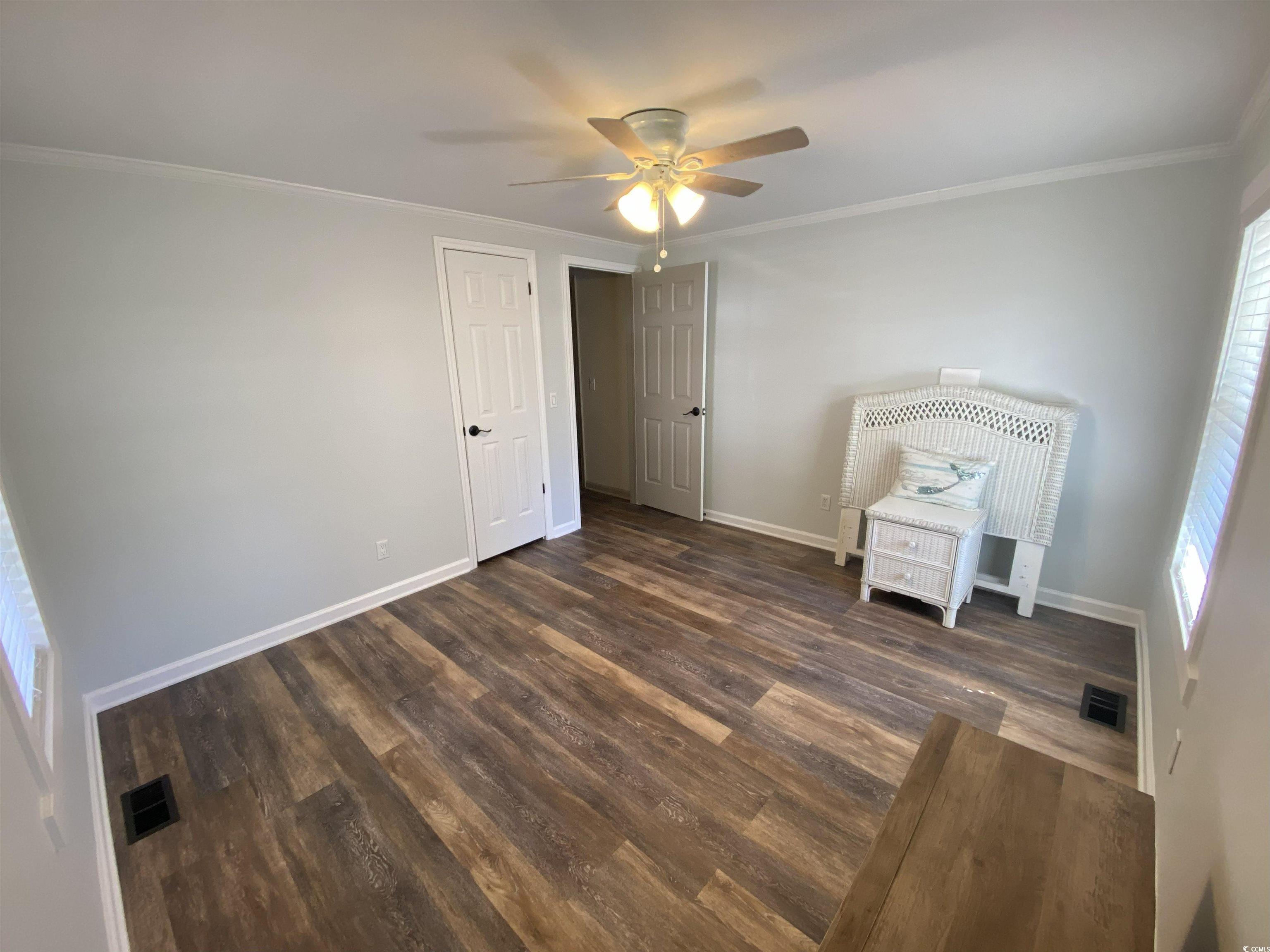 359 Lagoon Circle Murrells Inlet, SC 29576 - Photo 25 of 39 Unfurnished bedroom with ornamental molding, ceiling fan, and dark wood finished floors