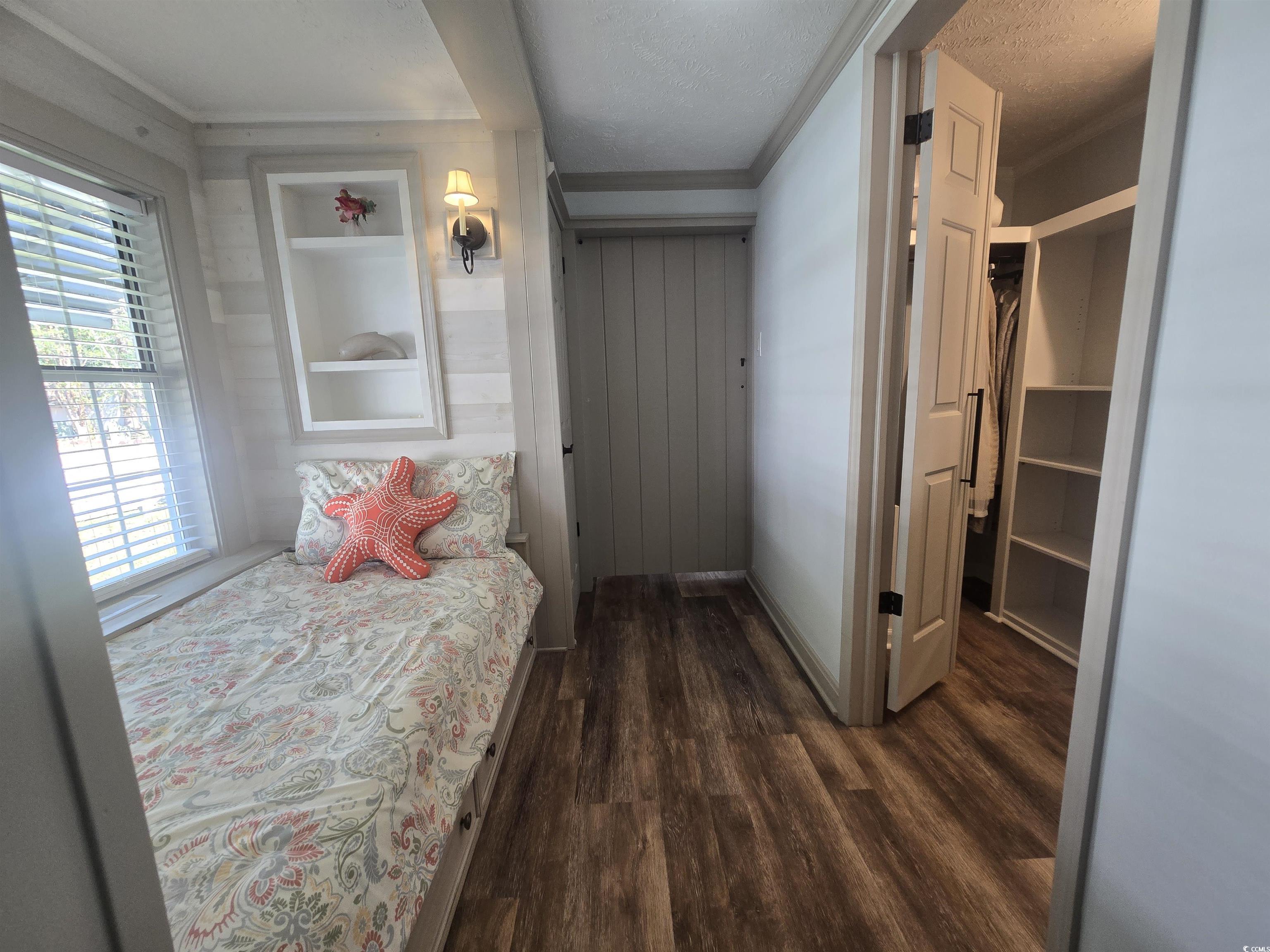 359 Lagoon Circle Murrells Inlet, SC 29576 - Photo 30 of 39 Bedroom with dark wood-style flooring, a textured ceiling, and crown molding