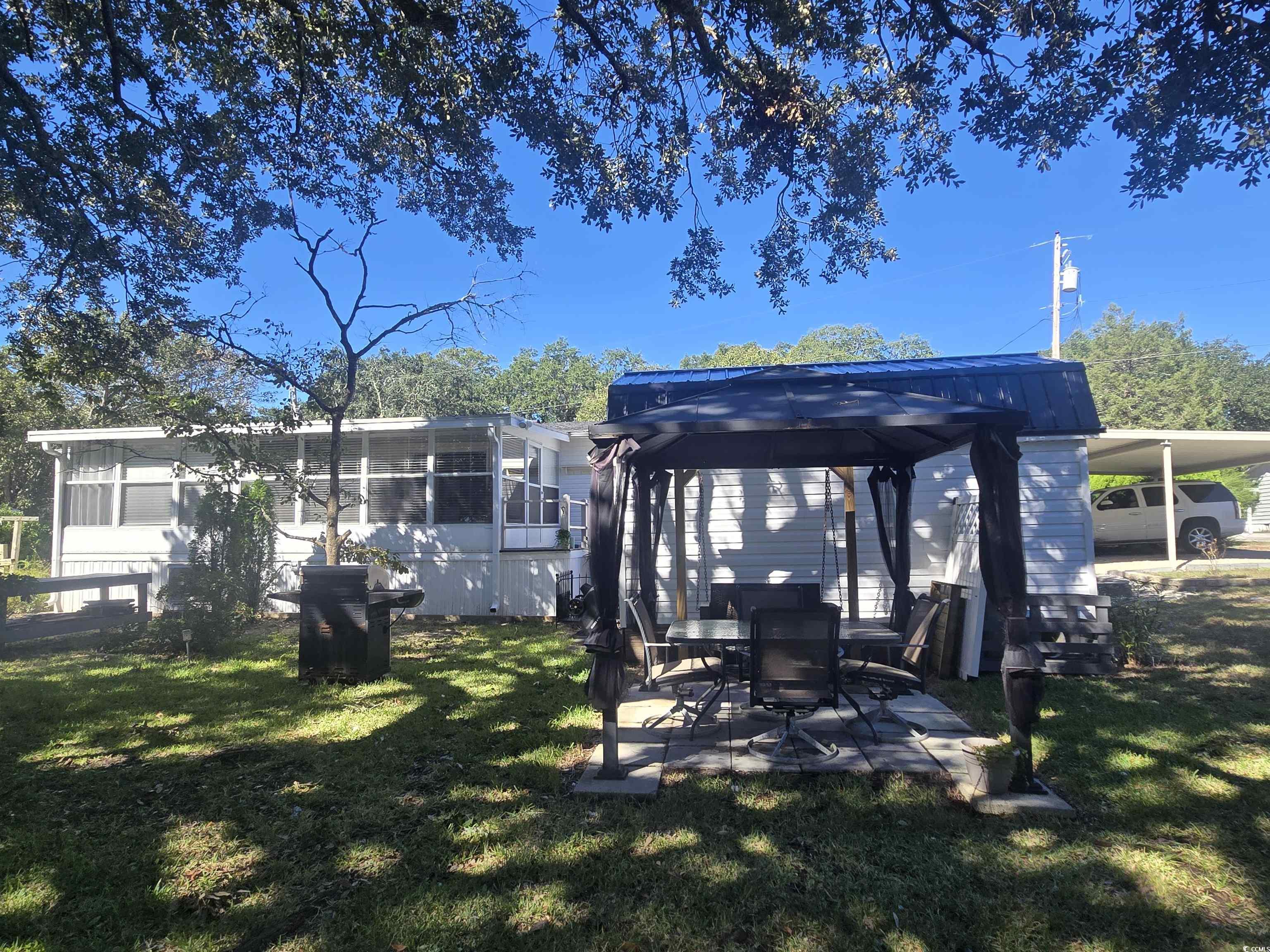 359 Lagoon Circle Murrells Inlet, SC 29576 - Photo 5 of 39 Dock area with a gazebo, a yard, and a patio