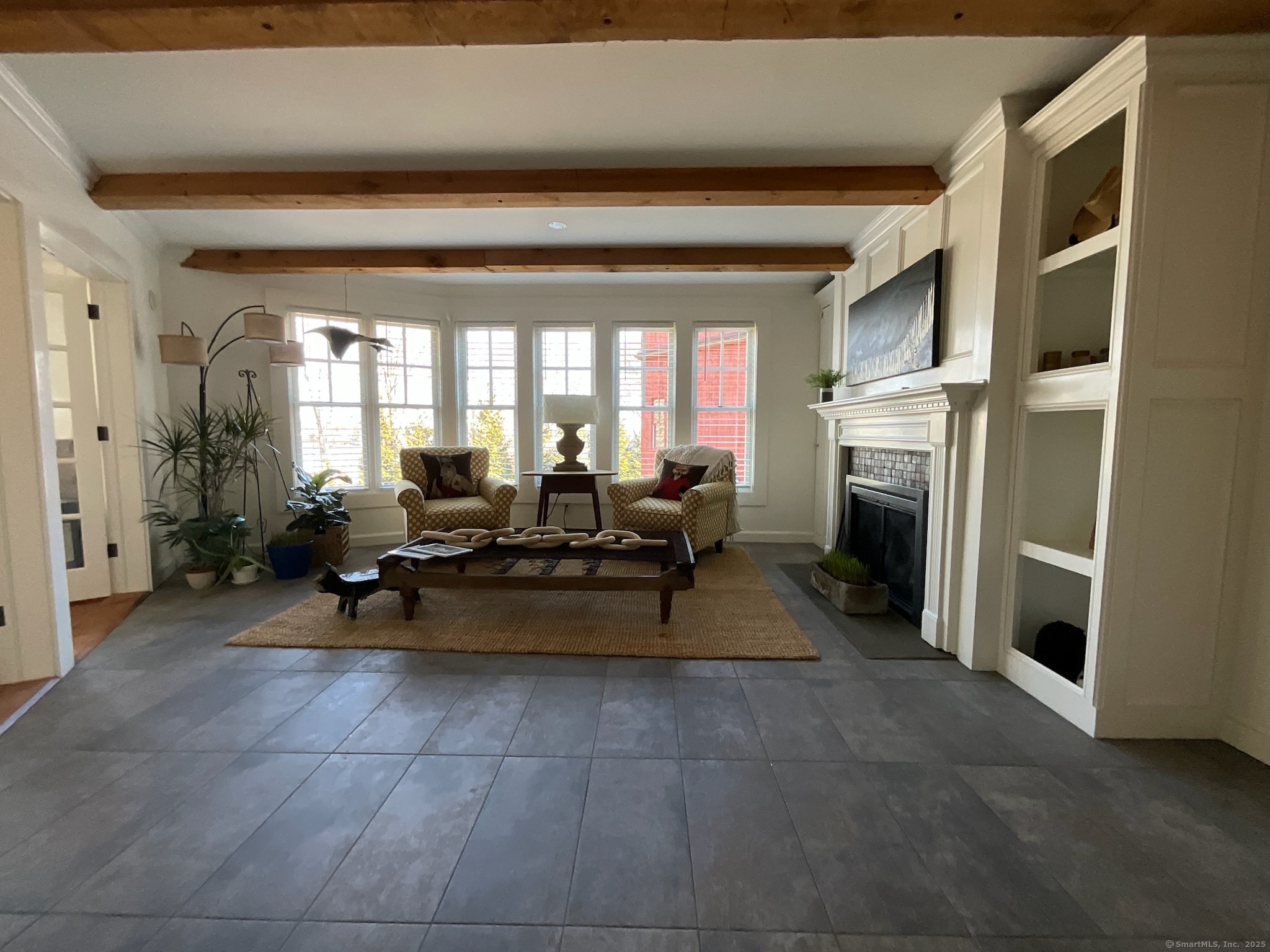 44 Brook Street Groton, CT 06340 - Photo 11 of 39 a living room with furniture a dining table and a fireplace