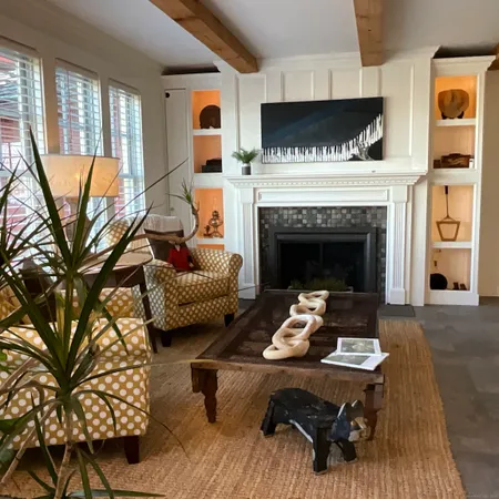 a living room with furniture a dining table and a fireplace