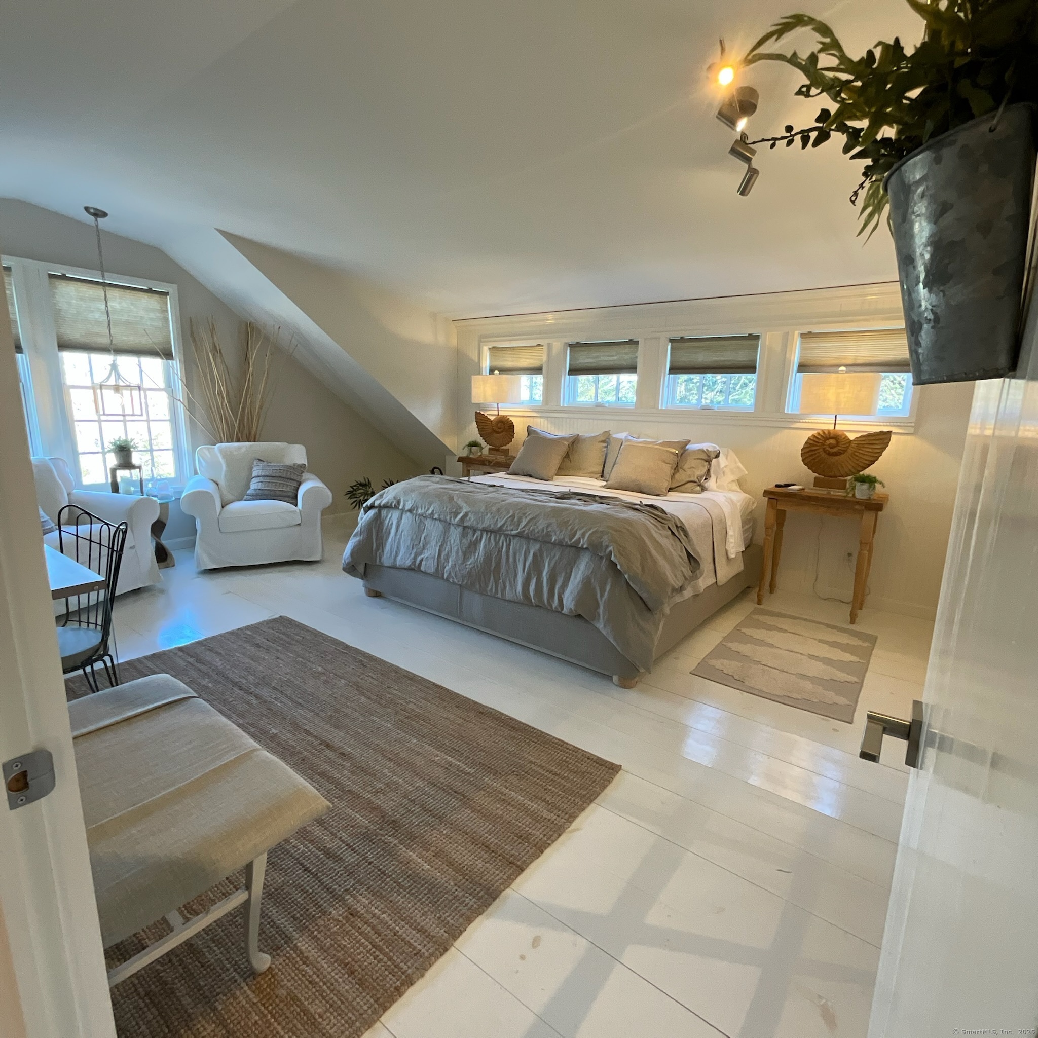 44 Brook Street Groton, CT 06340 - Photo 20 of 39 a spacious bedroom with a bed a couch and dresser