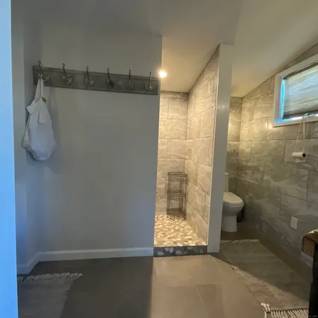 a spacious bedroom with a bed a couch and dresser