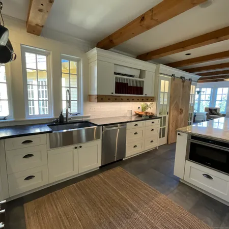 a kitchen with a table chairs and entryway
