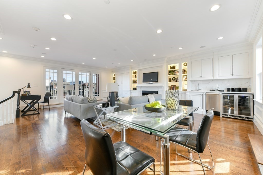 361 Beacon Street, Unit 3 Boston, MA 02116 - Photo 11 of 23 a view of kitchen with stainless steel appliances granite countertop dining table chairs stove and white cabinets