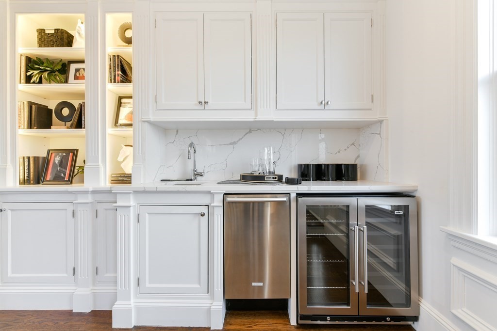 361 Beacon Street, Unit 3 Boston, MA 02116 - Photo 12 of 23 a kitchen with stainless steel appliances granite countertop white cabinets and window