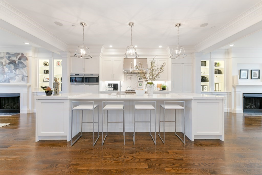 361 Beacon Street, Unit 3 Boston, MA 02116 - Photo 4 of 23 a large white kitchen with granite countertop a stove a sink a refrigerator and white cabinets with wooden floor